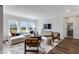 Bright living room with large windows, hardwood floors, neutral colors, and comfortable seating arrangement at 43 Fountainhead Ln, Garner, NC 27529