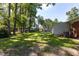 Shady green backyard with a boat parked beside the home at 438 N Hickory St, Angier, NC 27501