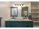 Bathroom featuring dual sinks, granite countertop and custom cabinets at 438 N Hickory St, Angier, NC 27501