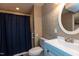 Tiled bathroom with shower/tub, toilet, and vanity with bright lighting at 438 N Hickory St, Angier, NC 27501