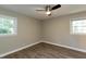 A bedroom with hardwood floors, a ceiling fan, and two windows at 438 N Hickory St, Angier, NC 27501