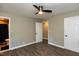 Bedroom featuring two closets, bathroom entrance, hardwood floors, and ceiling fan at 438 N Hickory St, Angier, NC 27501
