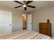 Bedroom showing hardwood floors, chest of drawers, closet, and ensuite bathroom entrance at 438 N Hickory St, Angier, NC 27501