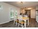 Eat-in kitchen and dining room boasts stainless appliances and stylish white table and chairs at 438 N Hickory St, Angier, NC 27501