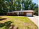 Lovely one-story brick home with manicured lawn and attached garage at 438 N Hickory St, Angier, NC 27501