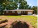 Charming single-story brick home with a well-maintained front lawn at 438 N Hickory St, Angier, NC 27501