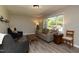 Comfortable living room boasts natural light, cozy seating, and serene ambiance at 438 N Hickory St, Angier, NC 27501
