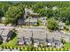 Aerial view showcasing well-maintained townhomes, lush trees, and ample parking spaces at 4649 Pine Trace Dr, Raleigh, NC 27613