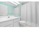 Bathroom with vanity, mirror, shower with curtain, and a toilet at 4649 Pine Trace Dr, Raleigh, NC 27613