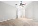 Bright bedroom features neutral carpet, vaulted ceiling, window, and ceiling fan at 4649 Pine Trace Dr, Raleigh, NC 27613