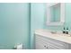 Cozy half bathroom with a white vanity, mirror, and soft blue walls at 4649 Pine Trace Dr, Raleigh, NC 27613