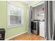 Efficient laundry room featuring modern washer and dryer, window, and storage space at 4649 Pine Trace Dr, Raleigh, NC 27613