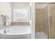 Bright bathroom features a soaking tub, separate shower, and tile surround at 4963 Highcroft Dr, Cary, NC 27519