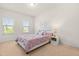 Bright bedroom with neutral carpeting, bedside table, and natural light at 4963 Highcroft Dr, Cary, NC 27519