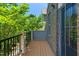 A wood deck with a black metal railing on a house with brick and gray siding at 4963 Highcroft Dr, Cary, NC 27519