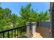 A wood deck with a black metal railing and trees behind it at 4963 Highcroft Dr, Cary, NC 27519