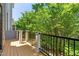 A wood deck with a black metal railing and trees behind it at 4963 Highcroft Dr, Cary, NC 27519