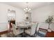 Elegant dining room features hardwood floors, chair rail, and modern chandelier at 4963 Highcroft Dr, Cary, NC 27519