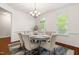Elegant dining room features hardwood floors, chair rail, and modern chandelier at 4963 Highcroft Dr, Cary, NC 27519