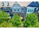 Exterior view of a townhome with stone and siding, well-manicured trees, and a covered entryway at 4963 Highcroft Dr, Cary, NC 27519