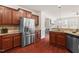 Kitchen with stainless steel appliances, granite countertops, hardwood floors, and view to the living room at 4963 Highcroft Dr, Cary, NC 27519