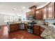 Kitchen with hardwood floors, granite countertops, stainless steel appliances, and view to living room at 4963 Highcroft Dr, Cary, NC 27519