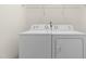 Laundry room with a white washer and dryer set and wire shelving above at 4963 Highcroft Dr, Cary, NC 27519