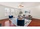 Open living room with hardwood floors, an area rug, a gray sofa, and blue accent chairs at 4963 Highcroft Dr, Cary, NC 27519