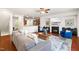 Open living room with fireplace, mounted TV, hardwood floors, and view of the kitchen at 4963 Highcroft Dr, Cary, NC 27519