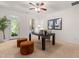 Brightly lit home office with a black desk, 2 brown poufs, and a view to the outside at 4963 Highcroft Dr, Cary, NC 27519