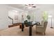 Bright home office with a ceiling fan, neutral carpet, a black desk, and a cream colored side chair at 4963 Highcroft Dr, Cary, NC 27519