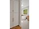 Bathroom with skylight, wood vanities, soaking tub, and storage cabinets at 503 Damascus Church Rd, Chapel Hill, NC 27516
