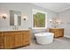 Luxury bathroom featuring double vanities, a soaking tub, and upscale fixtures at 503 Damascus Church Rd, Chapel Hill, NC 27516