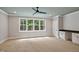 Spacious bonus room features built-in desk, a ceiling fan and a large window providing ample natural light at 503 Damascus Church Rd, Chapel Hill, NC 27516