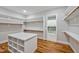 Walk-in closet features custom shelving, hardwood floors and a view into the laundry room at 503 Damascus Church Rd, Chapel Hill, NC 27516