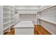 Walk-in closet features custom shelving, an island and hardwood floors at 503 Damascus Church Rd, Chapel Hill, NC 27516