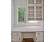 Built-in desk area with white cabinets, drawers, quartz counters and wooded view at 503 Damascus Church Rd, Chapel Hill, NC 27516