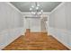 Spacious dining room with hardwood floors, wainscoting, and view of the home's staircase at 503 Damascus Church Rd, Chapel Hill, NC 27516