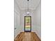 Stylish foyer featuring hardwood floors, wainscoting, and a unique modern light fixture at 503 Damascus Church Rd, Chapel Hill, NC 27516