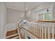 Hallway with decorative lighting and staircase overlooking bonus room at 503 Damascus Church Rd, Chapel Hill, NC 27516
