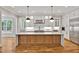 Modern kitchen with large center island, stainless steel appliances, and custom white cabinets at 503 Damascus Church Rd, Chapel Hill, NC 27516