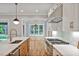 Open-concept kitchen with a spacious island, stainless steel appliances, and backyard views at 503 Damascus Church Rd, Chapel Hill, NC 27516