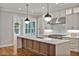 Gourmet kitchen featuring a large island with seating and high-end appliances and fixtures at 503 Damascus Church Rd, Chapel Hill, NC 27516