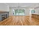 Spacious living room featuring hardwood floors, fireplace, and sliding glass doors to the outdoors at 503 Damascus Church Rd, Chapel Hill, NC 27516