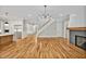 Open-concept living area with hardwood floors, fireplace, and staircase at 503 Damascus Church Rd, Chapel Hill, NC 27516