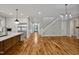 Open-concept living space with hardwood floors, a staircase, and views of the modern kitchen at 503 Damascus Church Rd, Chapel Hill, NC 27516
