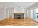Comfortable living room area featuring a modern fireplace, hardwood flooring and built-in benches at 503 Damascus Church Rd, Chapel Hill, NC 27516