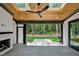 Covered patio with skylight, ceiling fan, wood ceiling, fireplace and wooded view at 503 Damascus Church Rd, Chapel Hill, NC 27516