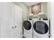 Convenient laundry room featuring a side by side washer and dryer and ample storage at 509 Kildaire Farm Rd # 305, Cary, NC 27511