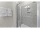Modern shower with glass door features tiled walls, built-in niche, and sleek fixtures at 509 Kildaire Farm Rd # 305, Cary, NC 27511